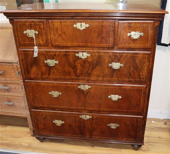 A George III walnut chest of drawers, on bun feet W.101cm